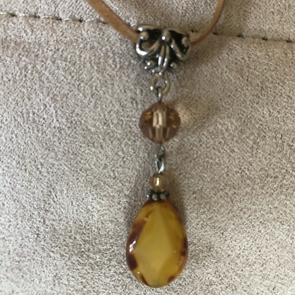 Amber stone choker with suede chain.
